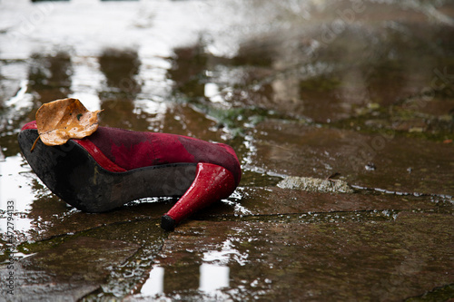Stop violence against women , concept photography, one red women shoe in the rain photo