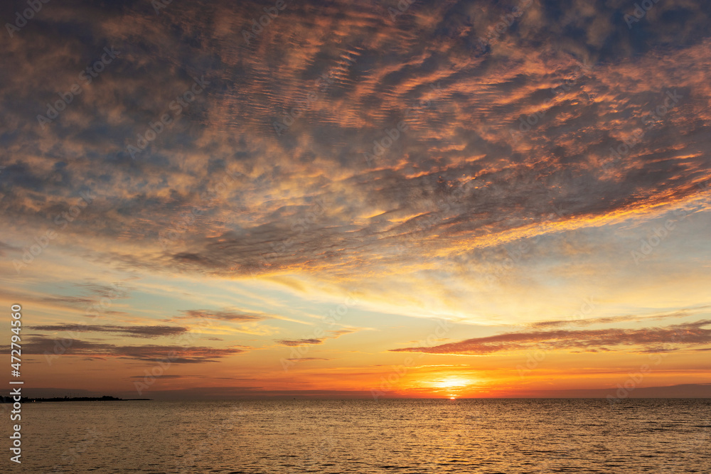 Vivid sunrise clouds over the Atlantic Ocean from Higgs Beach in Key West, Florida, USA