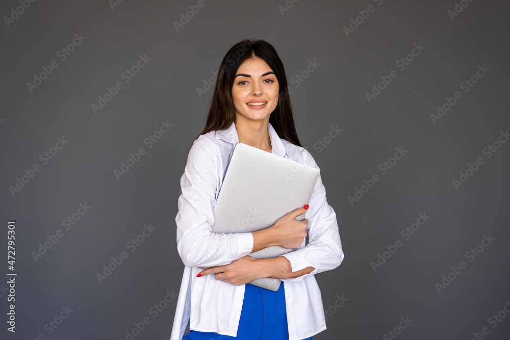 Young happy smiling woman holding laptop and sending email to her best friend Young happy smiling woman holding laptop and sending email to her best friend