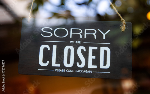 "Closed" tag on cafe or store hang on door glass at entrance ready to service. black wooden open tag