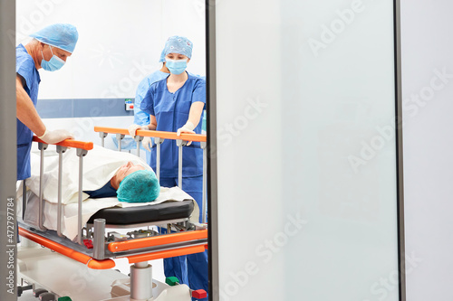 Surgeon and nurse take care of patient