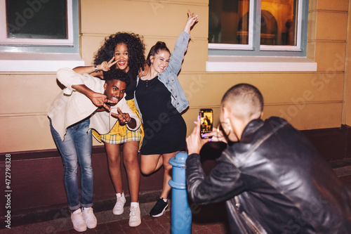 Gen z friends posing for a photo at night photo