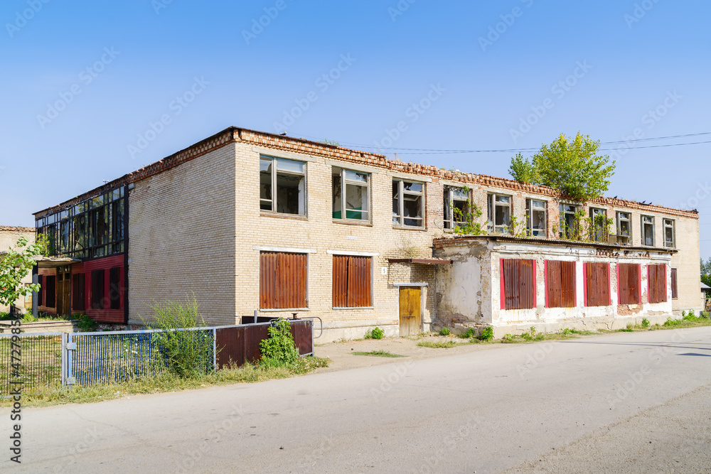 Abandoned building of the House of Culture in the Russian village. The picture was taken in Russia, in the Chelyabinsk region, in the village of Kalininsky Abandoned building of the House of Culture in the Russian village. The picture was taken in Russia, in the Chelyabinsk region, in the village of Kalininsky