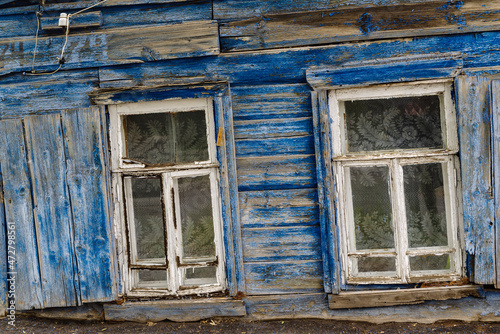Windows of a dilapidated rickety old wooden house. The picture was taken in Russia, in the city of Orenburg