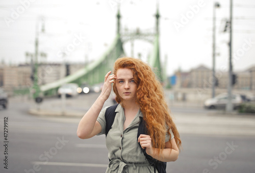 Photography young woman with backpacker in the street