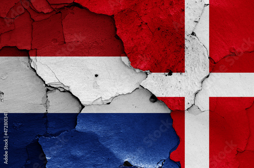 flags of Netherlands and Denmark painted on cracked wall