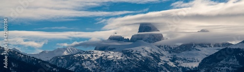 Panoramic of Grand Teton, Middle Teton and Mount Owen seen from the west with cloud layers.