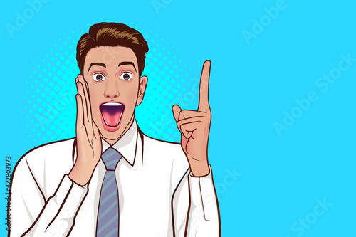 Cheerful young man shouting with hold hand near mouth and point up