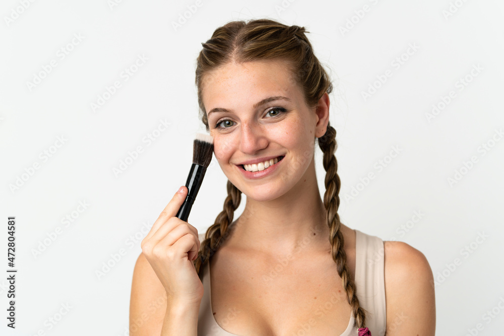 Young caucasian woman isolated on white background holding makeup brush Young caucasian woman isolated on white background holding makeup brush