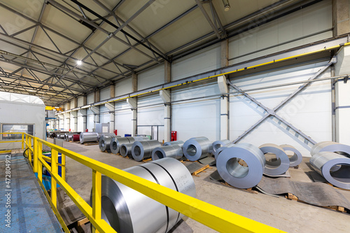 Production line of metal tile for roof. Steel forming machine in metalwork factory workshop