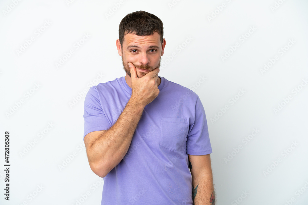 Young Brazilian man isolated on white background having doubts Young Brazilian man isolated on white background having doubts