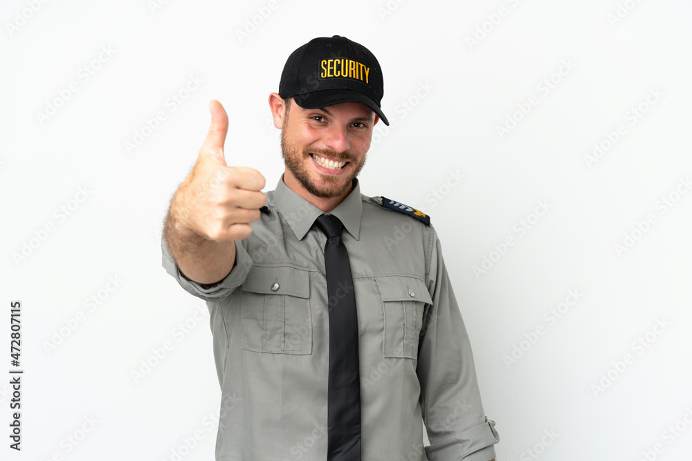 Young security Brazilian man isolated on white background with thumbs up because something good has happened Young security Brazilian man isolated on white background with thumbs up because something good has happened