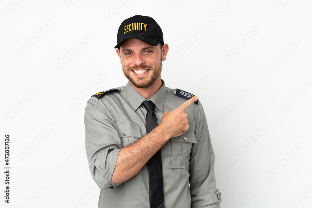 Young security Brazilian man isolated on white background pointing to the side to present a product Young security Brazilian man isolated on white background pointing to the side to present a product