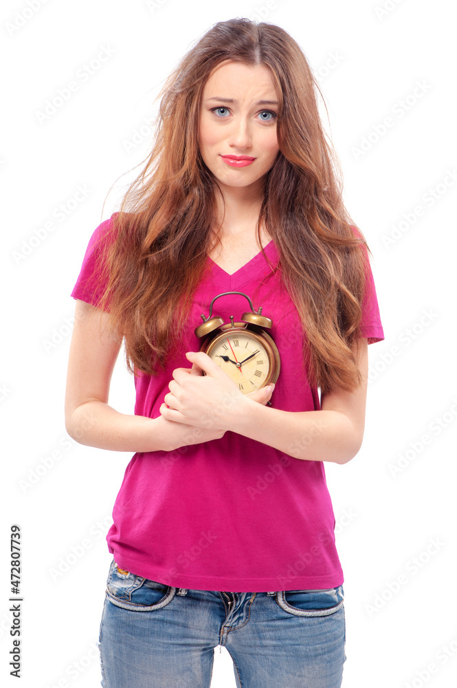 sleep through the alarm clock. Frustrated beautiful young woman with wild hair holding alarm clock, isolated on the white. sleep through the alarm clock. Frustrated beautiful young woman with wild hair holding alarm clock, isolated on the white.