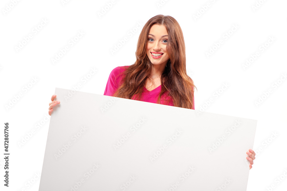Excited about... Beautiful young woman holding copy space and looking surprised while standing against white background. Excited about... Beautiful young woman holding copy space and looking surprised while standing against white background.