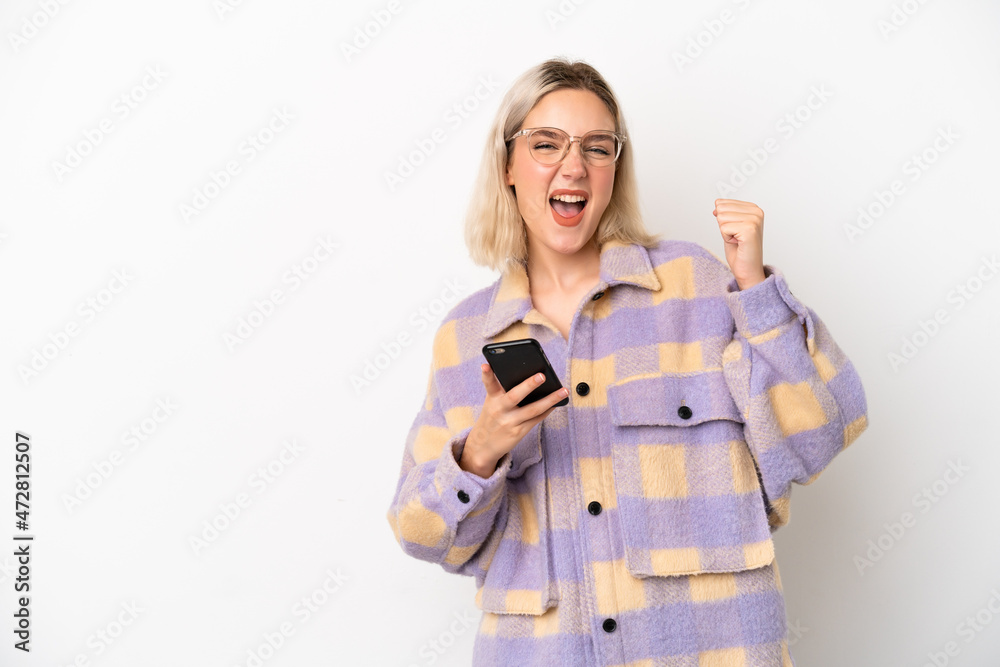 Young caucasian woman isolated on white background with phone in victory position Young caucasian woman isolated on white background with phone in victory position