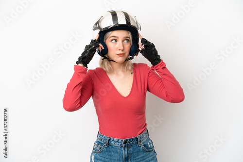 Young caucasian woman with a motorcycle helmet isolated on white background having doubts and thinking © luismolinero