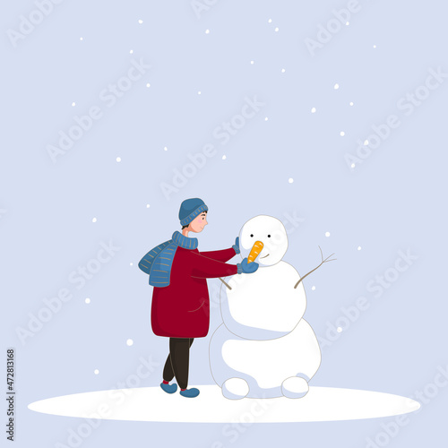 A boy makes a snowman on a snowy day. Winter holiday card.