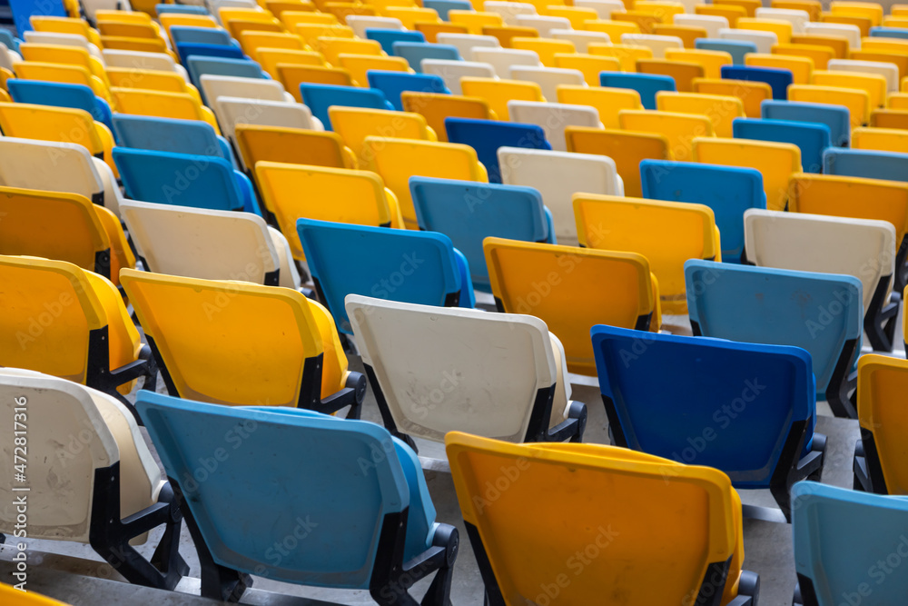 empty colorful seats on tribunes of stadium empty colorful seats on tribunes of stadium