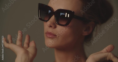 Beautiful Young Woman Trying On A Pair Of Sunglasses