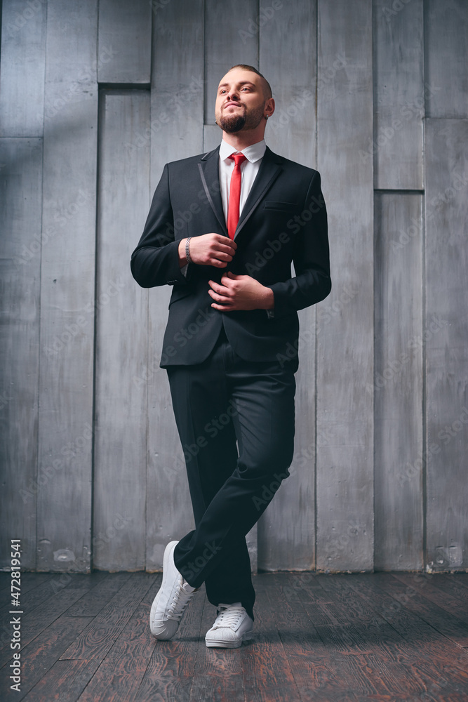 Elegance and style. Portrait of handsome young man wearing tuxedo and red tie. Elegance and style. Portrait of handsome young man wearing tuxedo and red tie.