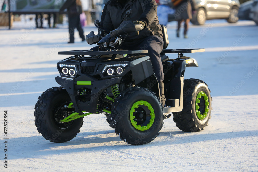Naklejka premium The ATV rides in the snow