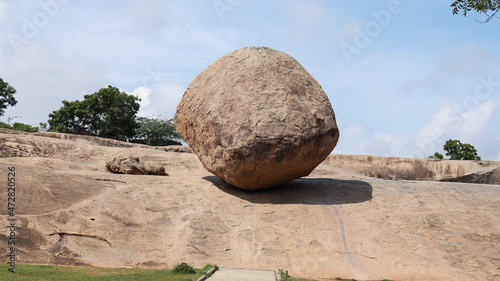 Krishna Butter Ball Large rock and blue sky. A balance rock. Located in the natural background.