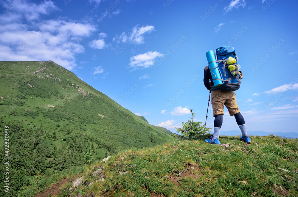 Obraz premium Active lifestyle. Traveling, hiking and trekking concept. Young man with backpack in the Carpathian mountains.