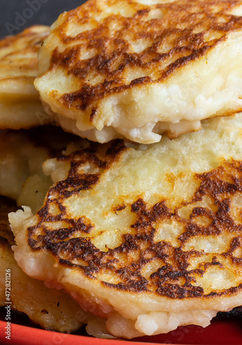 Cheese pancakes from pot cheese lies in red plate photo