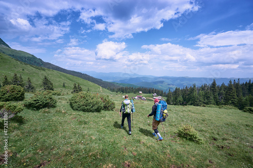 Active lifestyle. Traveling together. Couple of tourists with backpacks in the Carpathian mountains.