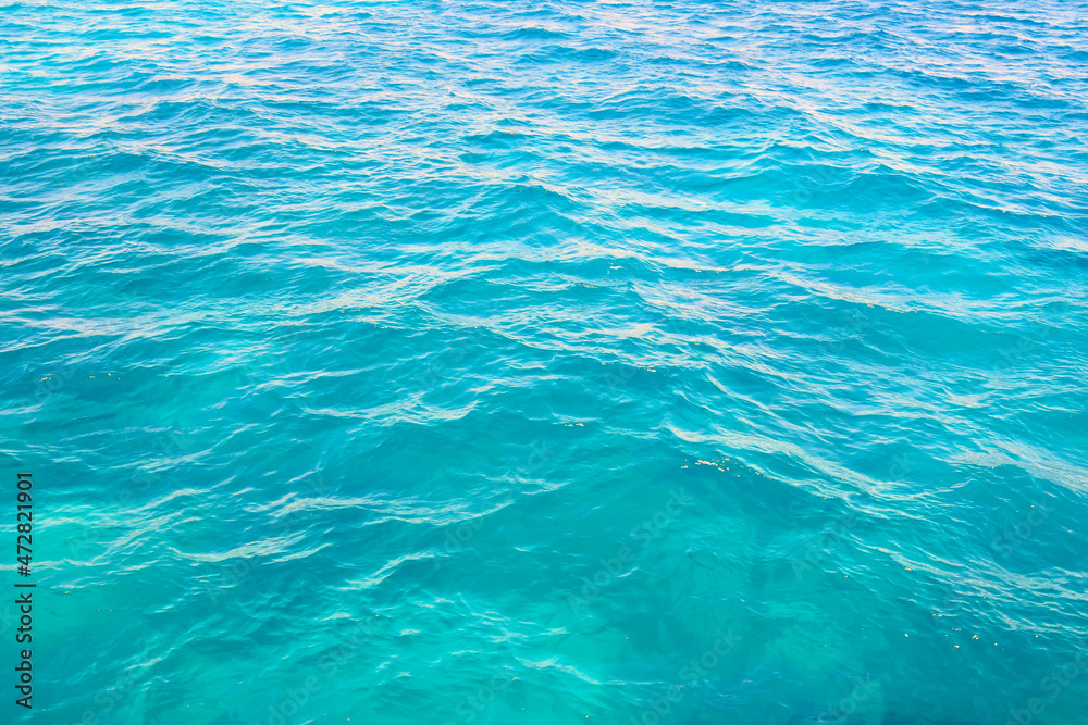 Abstract background. Waves of blue sea water. Copy space. Selective focus.