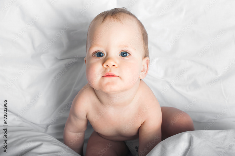 Child 1 year old on bed close-up.. Child 1 year old on bed close-up..