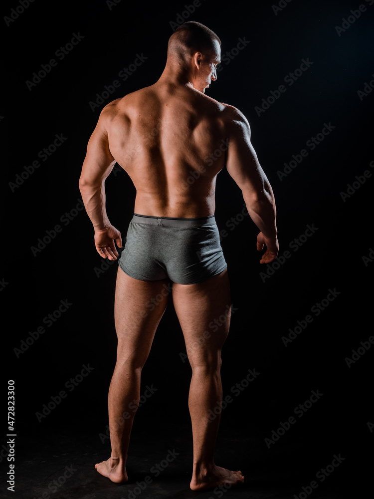 Portrait of strong man showing muscles isolated on black Portrait of strong man showing muscles isolated on black
