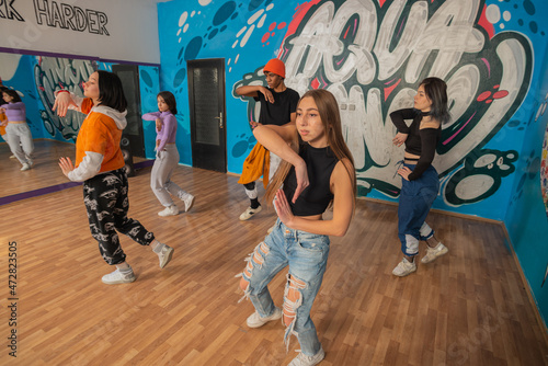 Young dancers in colorful wear having fun dancing hip-hop, enjoy being active. lifestyle, youth generation