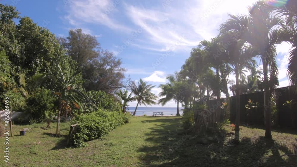 backyard with picnic table to beach side in walking close zoom in view look out to the ocean in sunny day with blue sky sunshine bright sun coconut trees flat tide wave locate in south pacific island backyard with picnic table to beach side in walking close zoom in view look out to the ocean in sunny day with blue sky sunshine bright sun coconut trees flat tide wave locate in south pacific island