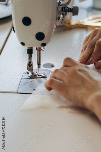 A creative person is making dress on the dressmaking table.