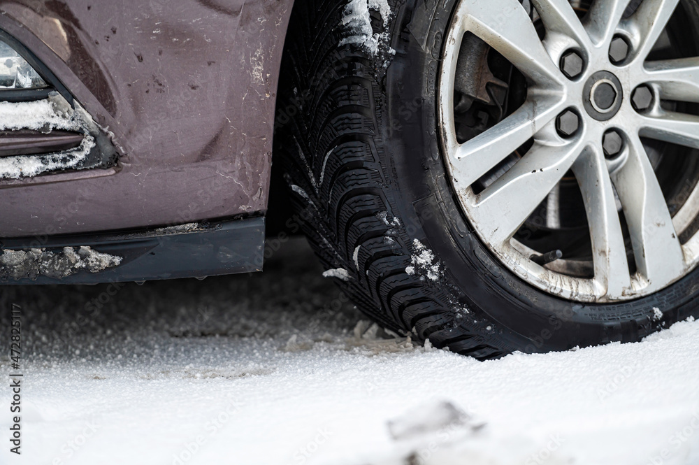 closeup of car wheels rubber tires in deep winter snow, transportation and safety concept