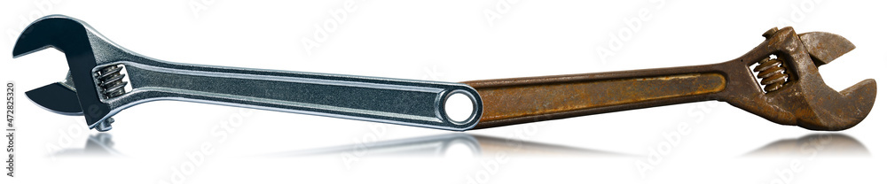 Closeup of two adjustable wrenches isolated on white background with reflections, one rusted and the other in stainless steel. Closeup of two adjustable wrenches isolated on white background with reflections, one rusted and the other in stainless steel.