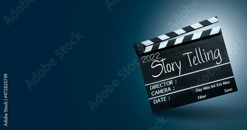 2022 storytelling, Handwriting on film slate or movie clapper board. Filming movies with amazing stories in the upcoming new year. photo