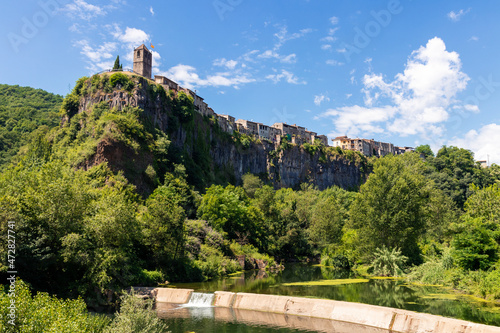 castellfollit de la roca in northern Spain with a small dam and a forest photo