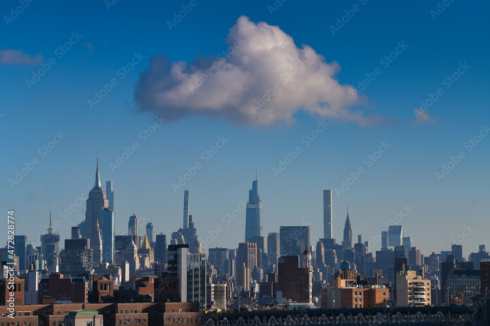 Fototapeta premium Travel to New York. The amazing skyline of Manhattan with these tall office building skyscrapers during the day. One of the most visited city in America.