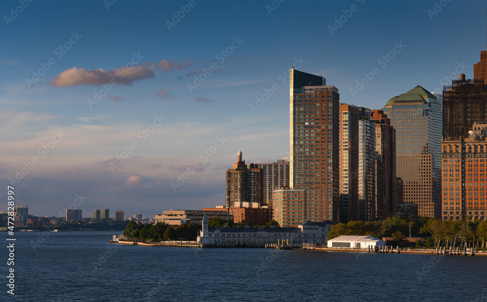 Fototapeta premium Skyline of Manhattan with its tall skyscraper buildings before sunrise. Visit New York, travel to America. One of the best places to see.