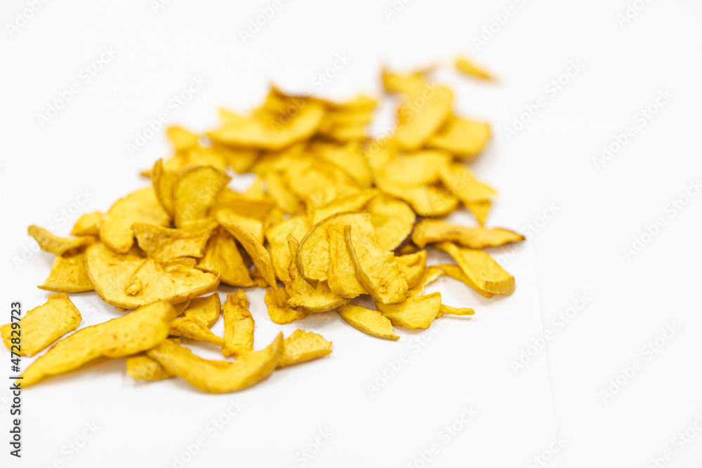 Sliced and dried apples on a conveyor belt in food processing facility Sliced and dried apples on a conveyor belt in food processing facility