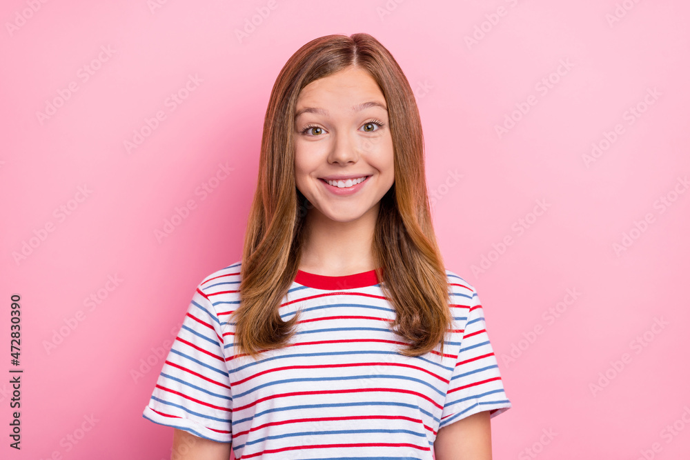 Photo of cute teenager girl look camera wear striped t-shirt isolated on pink color background Photo of cute teenager girl look camera wear striped t-shirt isolated on pink color background