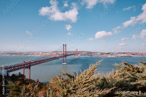 Beautiful landscape with suspension 25 April bridge bridge over the Tagus river in Lisbon, Portugal. photo
