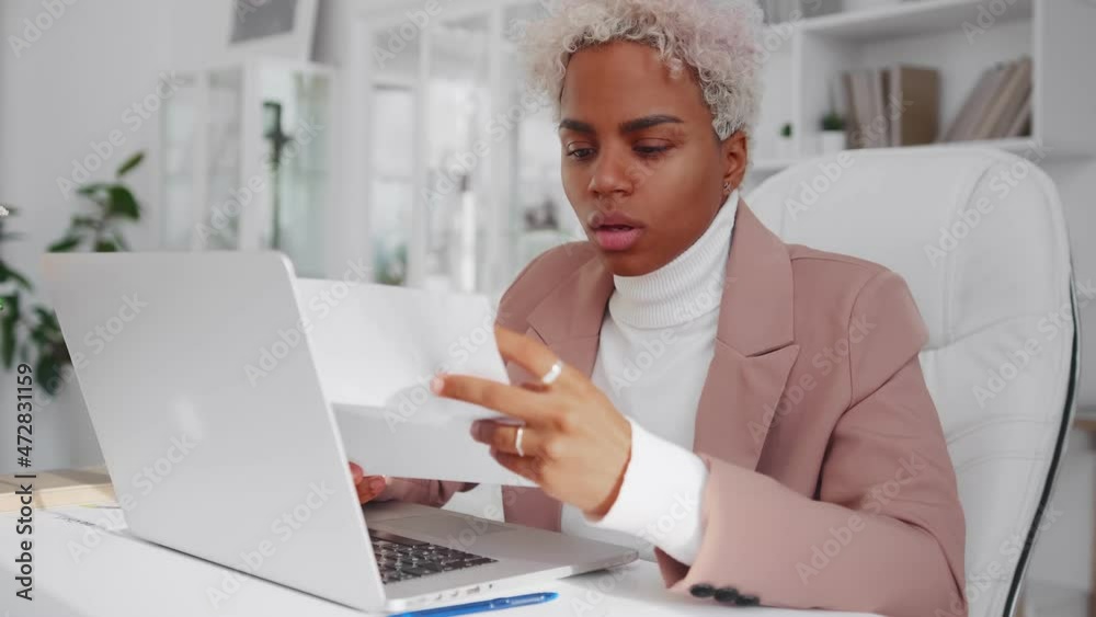 Excited African American woman reading good news in letter, rejoicing ...