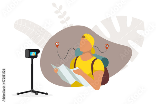 Tourist man vlogger holding map and looking route. Online streaming to camera on tripod. Travel blog content. Male backpacker influencer searching right direction. Traveler vlog stream eps concept