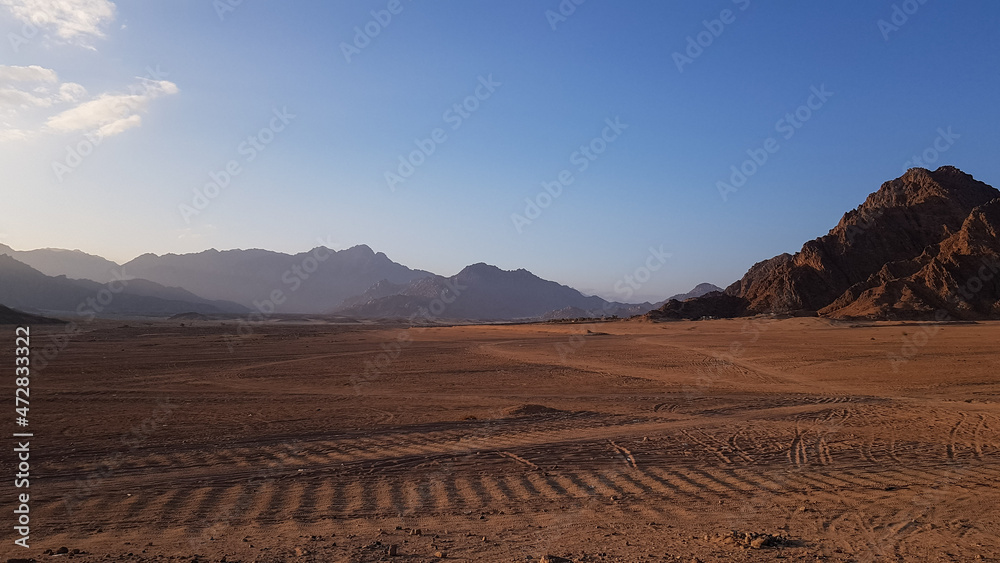 image of the desert and mountains on the Sinai Peninsula at sunset. The Sinai Desert is an attraction accessible to vacationers of all resort areas of Charm.excursion in Egypt. image of the desert and mountains on the Sinai Peninsula at sunset. The Sinai Desert is an attraction accessible to vacationers of all resort areas of Charm.excursion in Egypt.