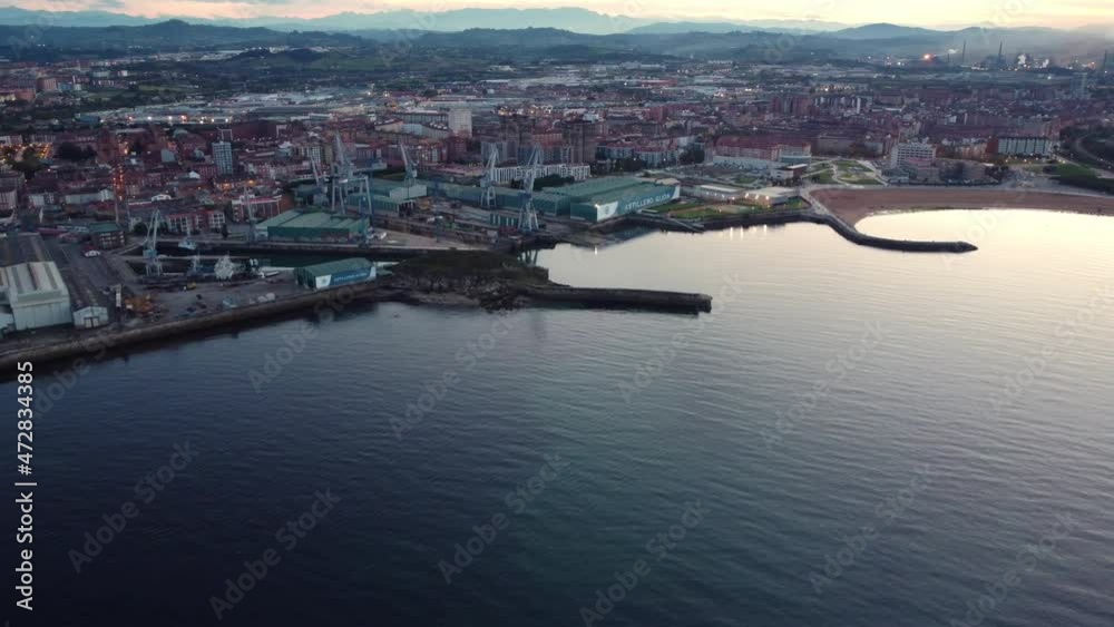 Aerial view of gijon city coastline in north Spain during sunset, sand beach and commercial harbor Aerial view of gijon city coastline in north Spain during sunset, sand beach and commercial harbor