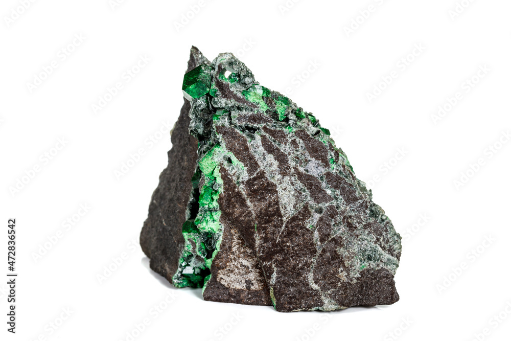 Macro stone garnet mineral, Uvarovite in rock on a white background Macro stone garnet mineral, Uvarovite in rock on a white background